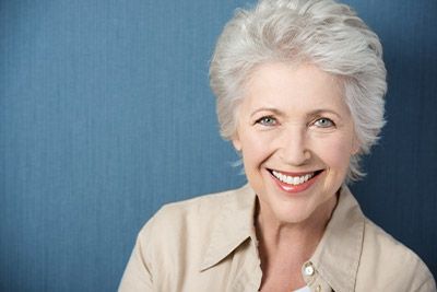 woman smiling with her new dental implants
